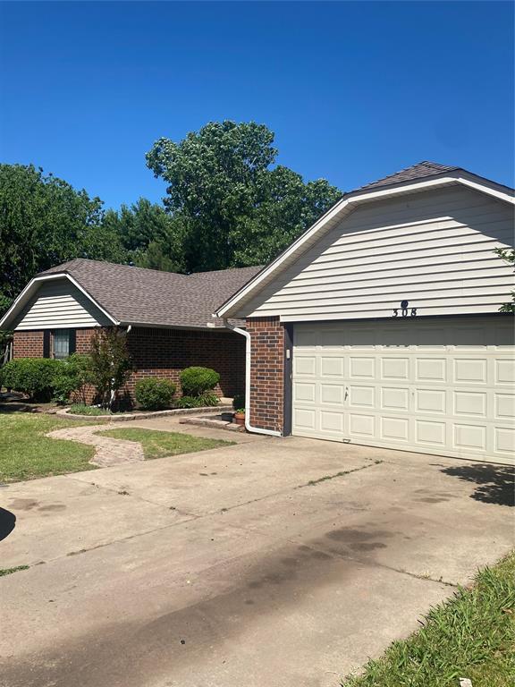 308 Jeffrey Laird Pl, Moore, OK 73160 - ranch-style home with brick siding, driveway, and a garage