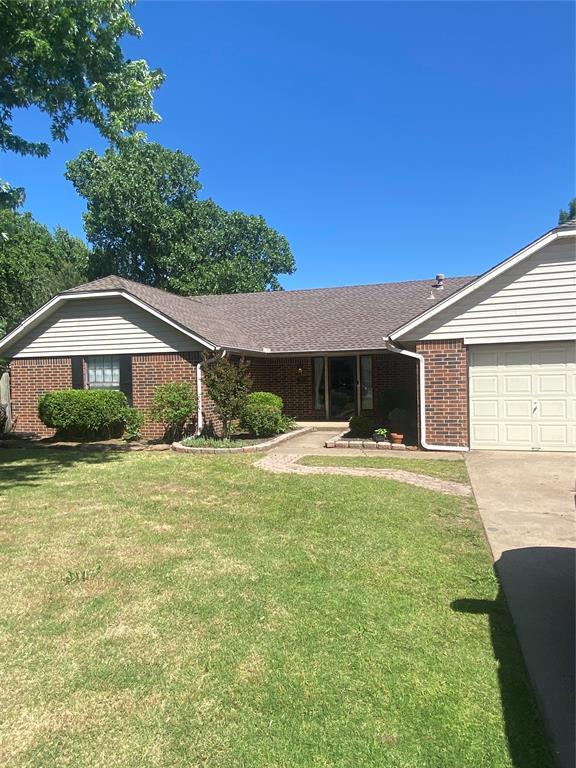 308 Jeffrey Laird Pl, Moore, OK 73160 - ranch-style house with brick siding, a garage, concrete driveway, and a front lawn