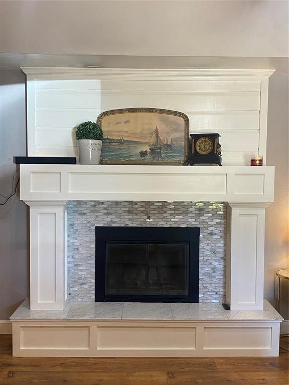 308 Jeffrey Laird Pl, Moore, OK 73160 - detailed view of wood finished floors and a tile fireplace