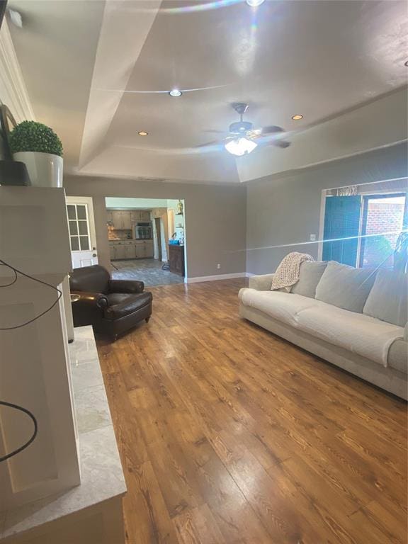 308 Jeffrey Laird Pl, Moore, OK 73160 - living area with a tray ceiling, wood finished floors, a ceiling fan, and recessed lighting