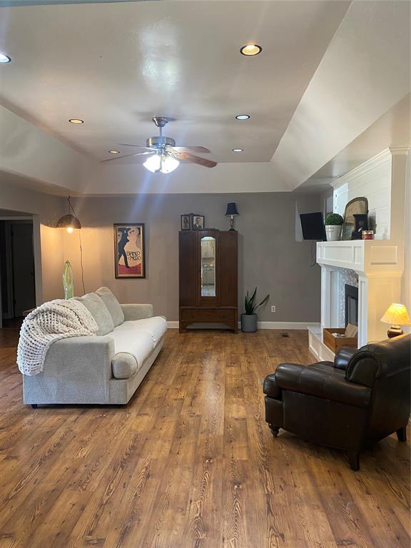 308 Jeffrey Laird Pl, Moore, OK 73160 - living room with wood finished floors, a ceiling fan, recessed lighting, and a tile fireplace