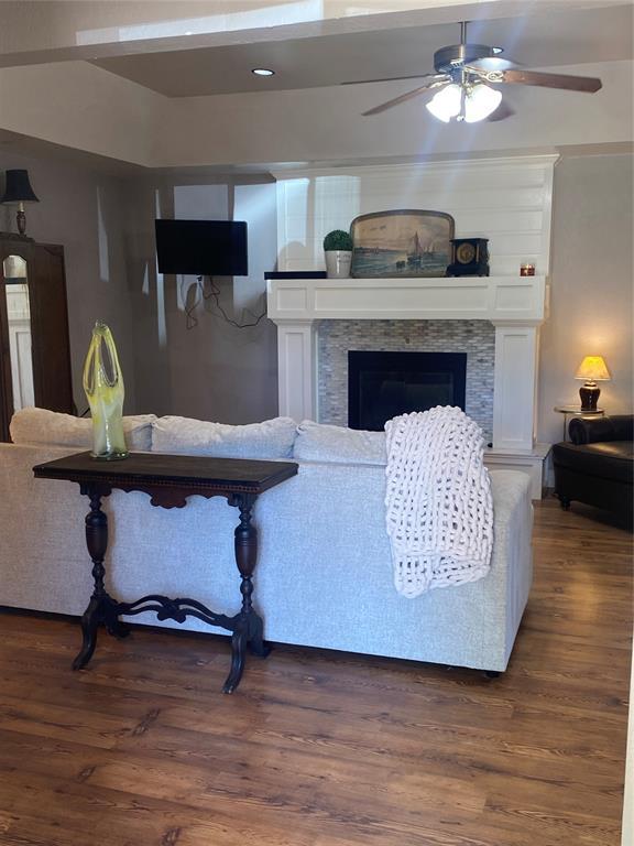 308 Jeffrey Laird Pl, Moore, OK 73160 - living room featuring ceiling fan, a fireplace, and dark wood finished floors