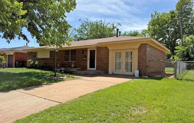 2405 S Mansfield St, Del City, OK 73115 - ranch-style house featuring brick siding, french doors, and a gate