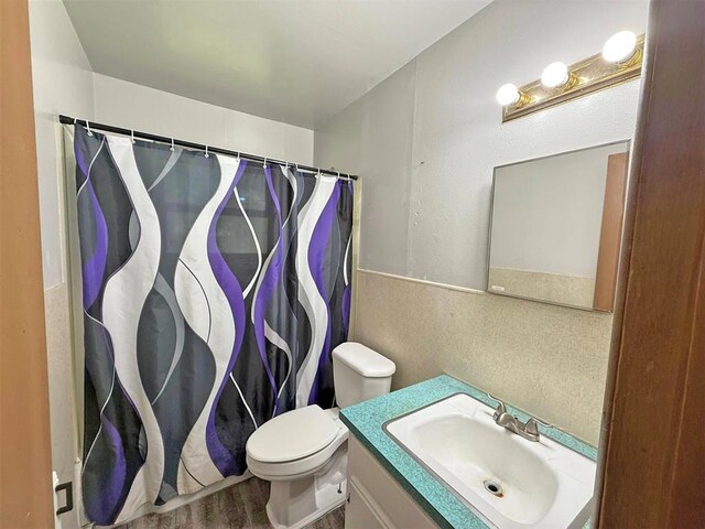 2405 S Mansfield St, Del City, OK 73115 - bathroom featuring toilet, vanity, a shower with curtain, and wood finished floors
