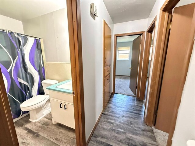 2405 S Mansfield St, Del City, OK 73115 - bathroom with vanity, wood finished floors, toilet, and curtained shower