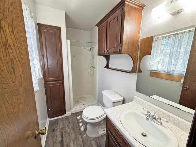 2405 S Mansfield St, Del City, OK 73115 - full bathroom featuring vanity, a shower stall, wood finished floors, and toilet
