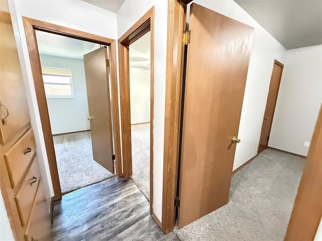 2405 S Mansfield St, Del City, OK 73115 - hall with carpet floors, wood finished floors, and baseboards