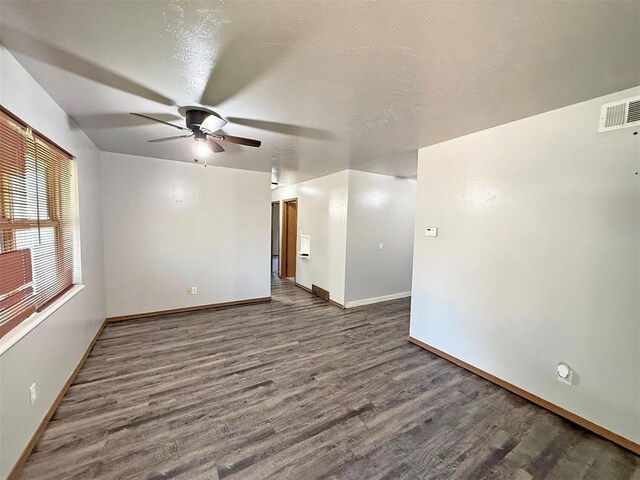 2405 S Mansfield St, Del City, OK 73115 - unfurnished room featuring a ceiling fan, wood finished floors, and baseboards