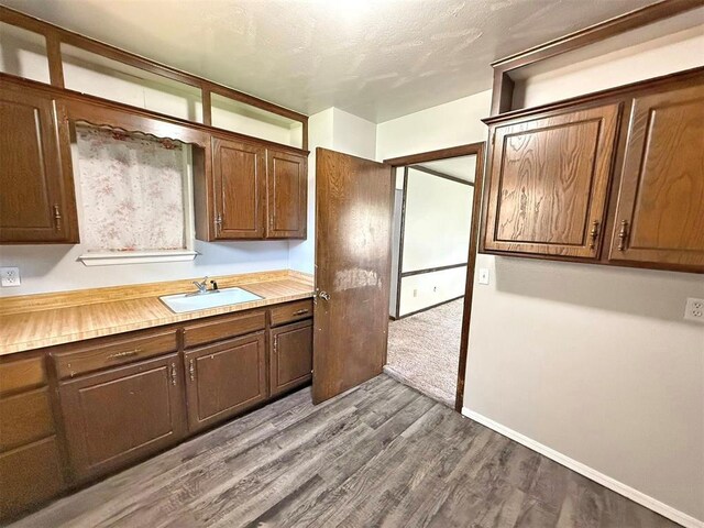 2405 S Mansfield St, Del City, OK 73115 - kitchen featuring a sink, dark wood-type flooring, and light countertops