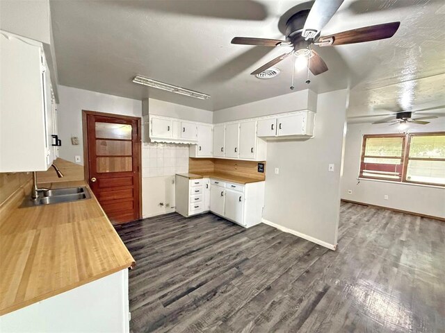 2405 S Mansfield St, Del City, OK 73115 - kitchen featuring a sink, a ceiling fan, dark wood finished floors, and white cabinets
