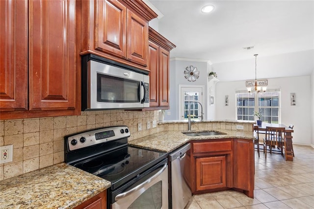 7713 Geneva Rea Ln, Yukon, OK 73099 - kitchen featuring stainless steel appliances, a sink, a chandelier, light tile patterned floors, and a peninsula