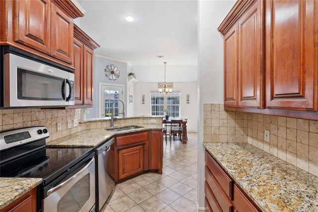 7713 Geneva Rea Ln, Yukon, OK 73099 - kitchen featuring stainless steel appliances, a sink, a chandelier, backsplash, and recessed lighting