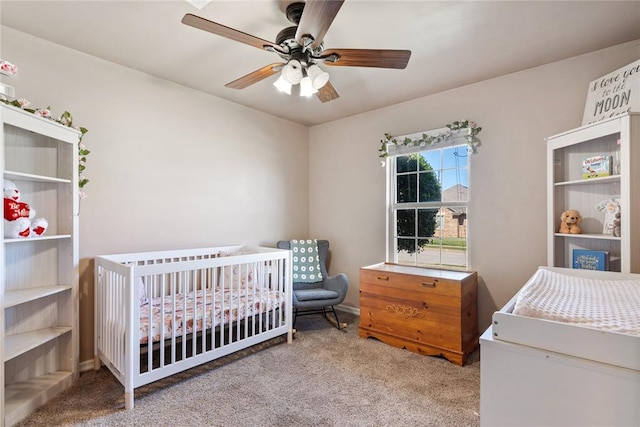 7713 Geneva Rea Ln, Yukon, OK 73099 - bedroom with carpet floors, a crib, and a ceiling fan