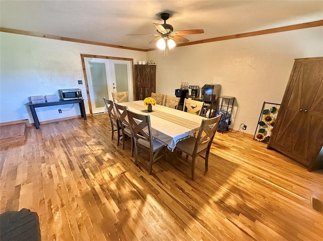 129 Park Dr, Sayre, OK 73662 - dining area featuring light wood-style flooring, a ceiling fan, french doors, ornamental molding, and baseboards