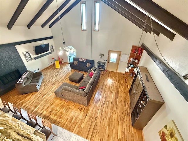 129 Park Dr, Sayre, OK 73662 - living area with wood finished floors, high vaulted ceiling, and beamed ceiling