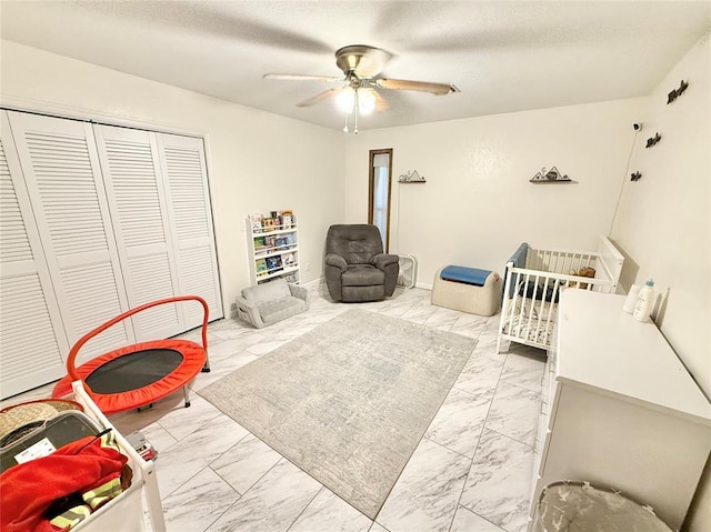 129 Park Dr, Sayre, OK 73662 - bedroom featuring marble finish flooring, a closet, a ceiling fan, and a textured ceiling