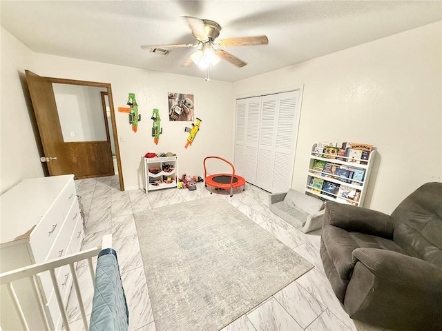 129 Park Dr, Sayre, OK 73662 - bedroom featuring light marble finish flooring, a closet, and ceiling fan