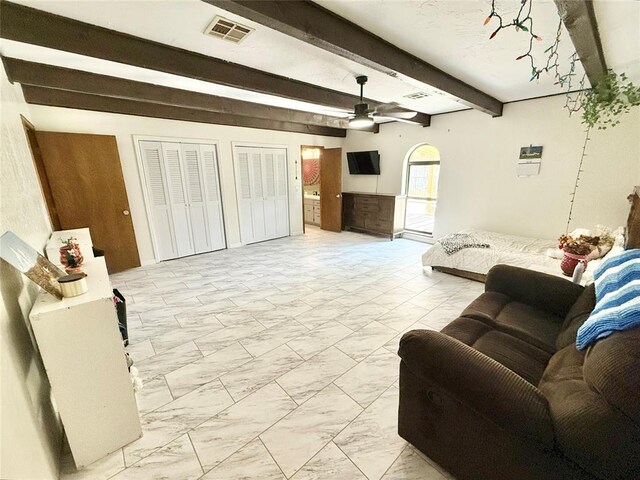 129 Park Dr, Sayre, OK 73662 - living room with light marble finish flooring, ceiling fan, and beamed ceiling