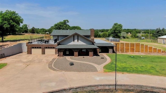 129 Park Dr, Sayre, OK 73662 - view of front of home featuring concrete driveway, brick siding, a garage, a chimney, and view of wooded area