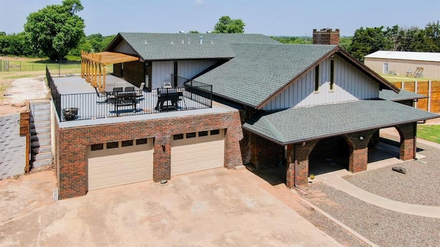 129 Park Dr, Sayre, OK 73662 - view of front of property with driveway, board and batten siding, a chimney, a garage, and roof with shingles