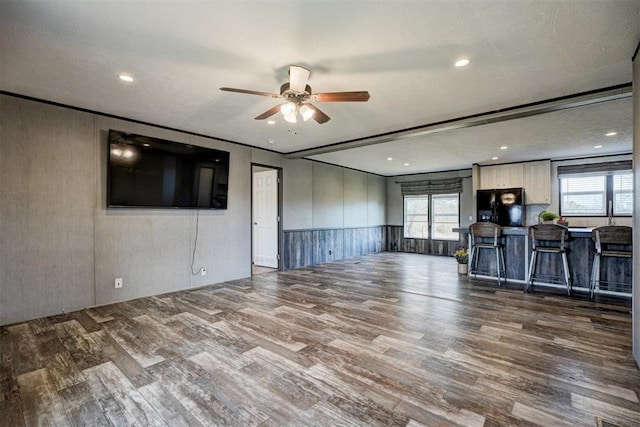 177074 Stephens Rd, Duncan, OK 73533 - unfurnished living room with wood finished floors, a ceiling fan, a wainscoted wall, and recessed lighting