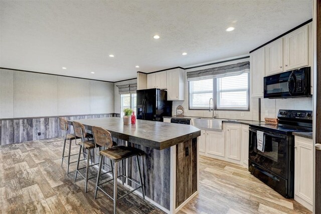 177074 Stephens Rd, Duncan, OK 73533 - kitchen with black appliances, recessed lighting, a sink, decorative backsplash, and light wood-style floors