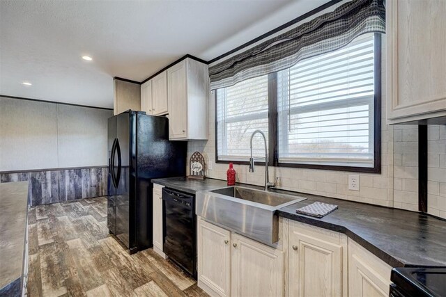 177074 Stephens Rd, Duncan, OK 73533 - kitchen with black appliances, a sink, dark countertops, backsplash, and wood finished floors