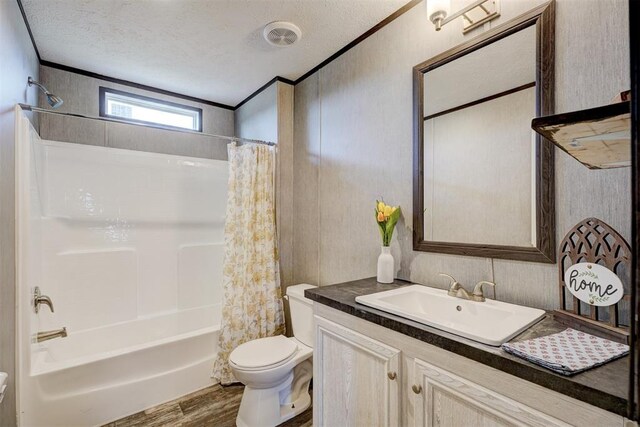 177074 Stephens Rd, Duncan, OK 73533 - full bath with toilet, vanity, shower / bath combination with curtain, a textured ceiling, and wood finished floors