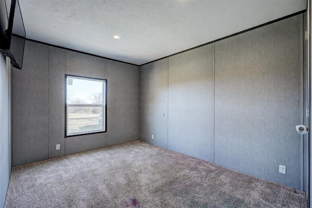 177074 Stephens Rd, Duncan, OK 73533 - carpeted spare room with a textured ceiling and a decorative wall