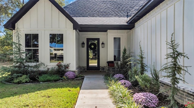 8913 Pear St, Kingston, OK 73439 - doorway to property with board and batten siding, a shingled roof, and a yard