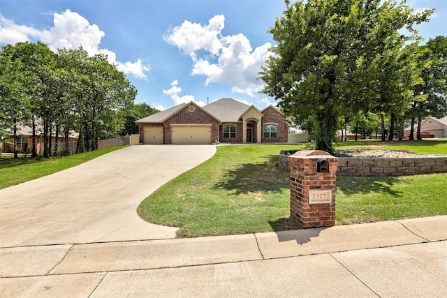 3327 Bobcat Trl, Guthrie, OK 73044 - view of front of house with a garage, concrete driveway, and brick siding
