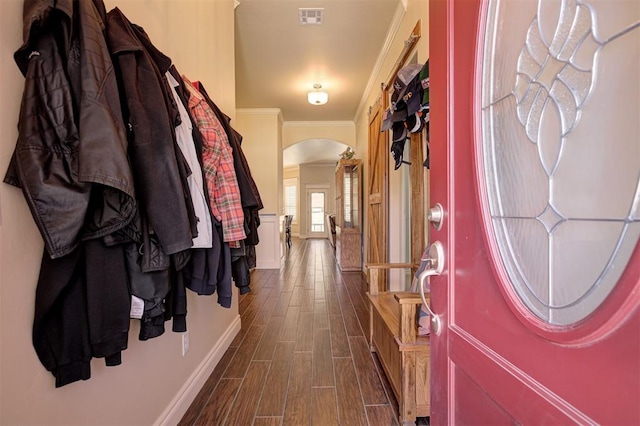 3327 Bobcat Trl, Guthrie, OK 73044 - foyer entrance featuring arched walkways, dark wood-style flooring, and crown molding