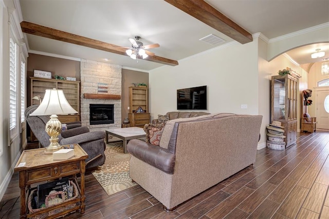 3327 Bobcat Trl, Guthrie, OK 73044 - living room with arched walkways, beam ceiling, dark wood-style flooring, ceiling fan, and plenty of natural light