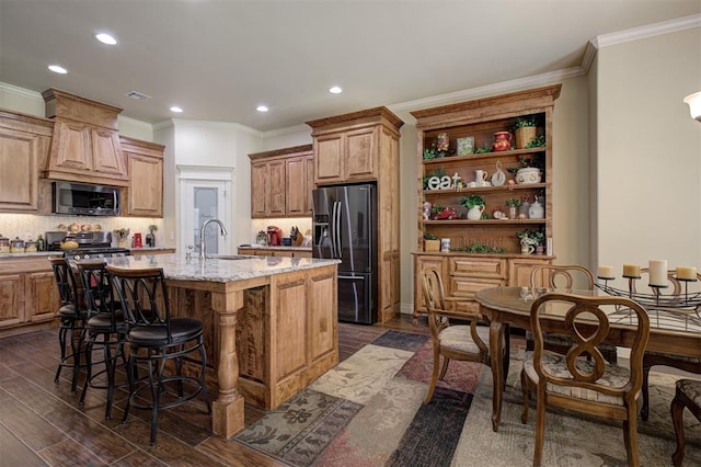 3327 Bobcat Trl, Guthrie, OK 73044 - kitchen with refrigerator with ice dispenser, stainless steel microwave, dark wood-type flooring, a kitchen breakfast bar, and crown molding