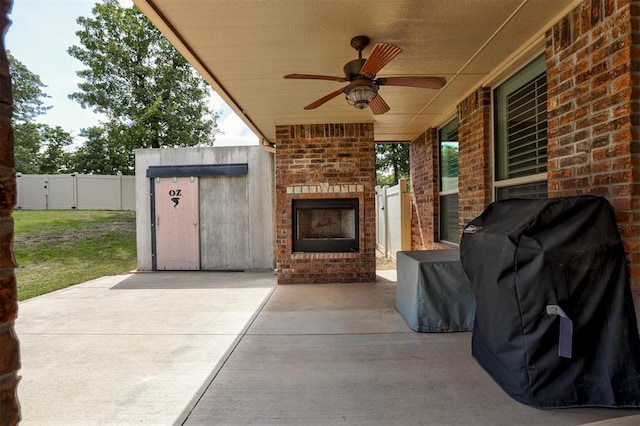 3327 Bobcat Trl, Guthrie, OK 73044 - fenced backyard featuring an outdoor brick fireplace, grilling area, a patio, and ceiling fan