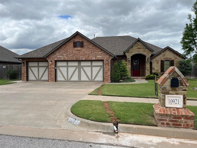 10921 SW 20th St, Yukon, OK 73099 - view of front facade with a garage, concrete driveway, a shingled roof, and brick siding
