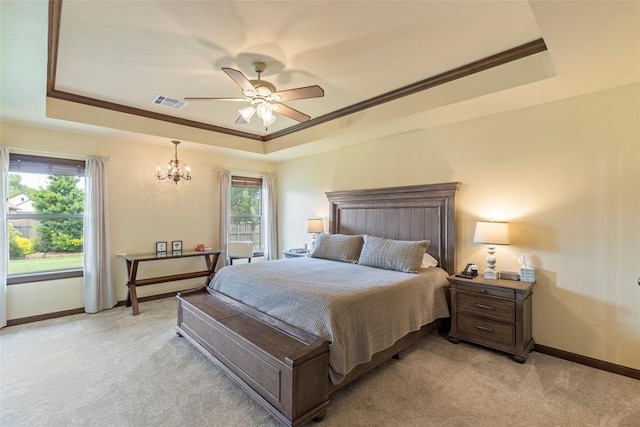 10921 SW 20th St, Yukon, OK 73099 - bedroom featuring a raised ceiling, light carpet, a chandelier, and baseboards