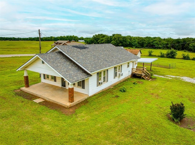 344020 E 760th Rd, Agra, OK 74824 - back of property featuring a patio area, a shingled roof, a lawn, and a carport