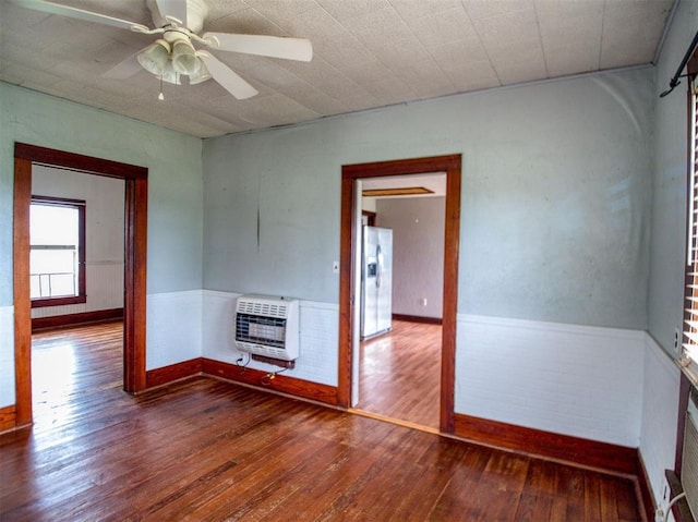 344020 E 760th Rd, Agra, OK 74824 - empty room featuring heating unit, wood-type flooring, baseboards, and ceiling fan