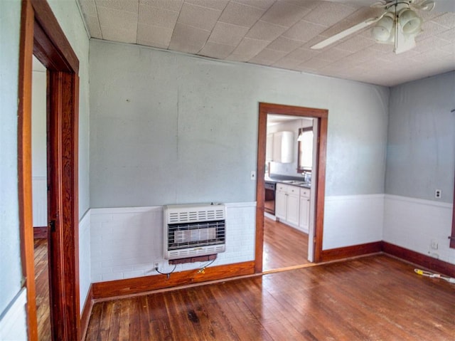 344020 E 760th Rd, Agra, OK 74824 - unfurnished living room featuring heating unit, ceiling fan, hardwood / wood-style floors, and a sink