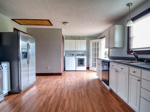 344020 E 760th Rd, Agra, OK 74824 - kitchen featuring stainless steel fridge with ice dispenser, dishwasher, washing machine and dryer, a sink, and light wood-type flooring