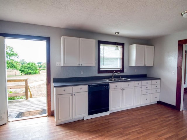 344020 E 760th Rd, Agra, OK 74824 - kitchen with dishwasher, a sink, a textured ceiling, dark countertops, and wood finished floors