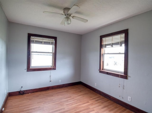 344020 E 760th Rd, Agra, OK 74824 - empty room featuring light wood-style floors, baseboards, ceiling fan, and a textured ceiling
