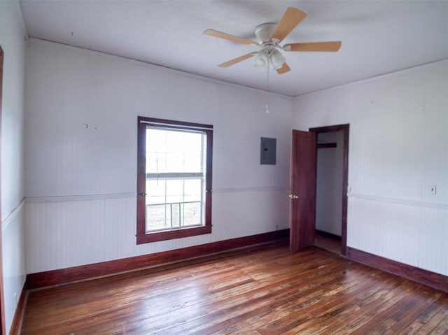 344020 E 760th Rd, Agra, OK 74824 - unfurnished room featuring hardwood / wood-style floors, electric panel, a wainscoted wall, a ceiling fan, and baseboards