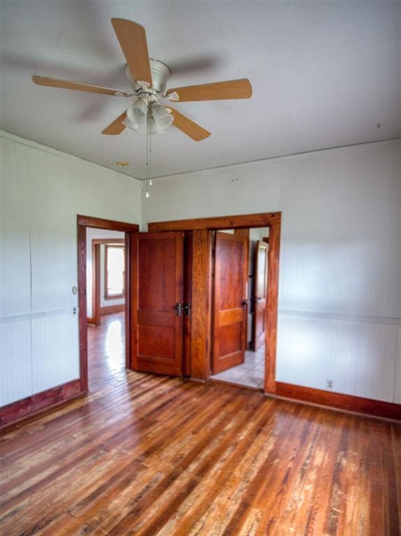 344020 E 760th Rd, Agra, OK 74824 - unfurnished room with light wood finished floors, ceiling fan, wainscoting, and baseboards