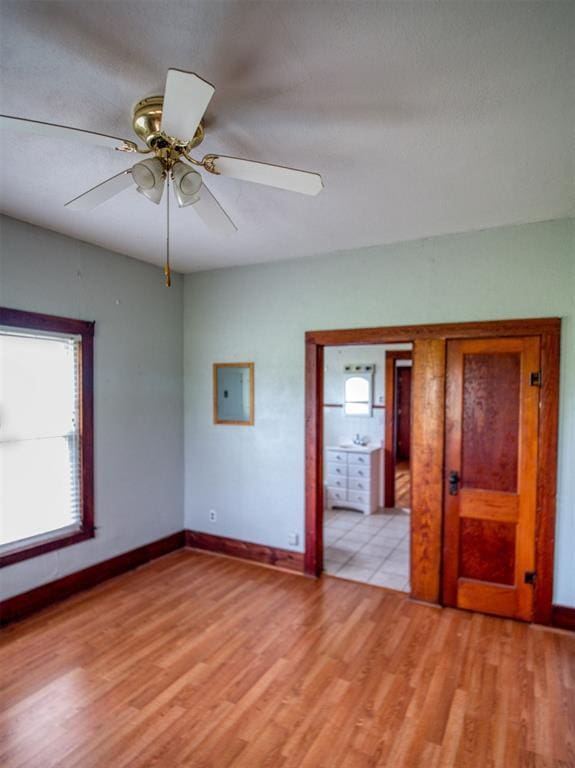 344020 E 760th Rd, Agra, OK 74824 - empty room with electric panel, light wood-style floors, baseboards, and a ceiling fan