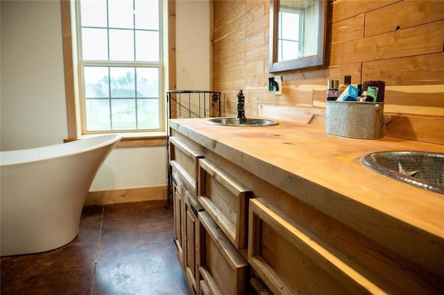 16301 Lewis Rd, Lexington, OK 73051 - bathroom with a soaking tub, double vanity, concrete flooring, and wood walls