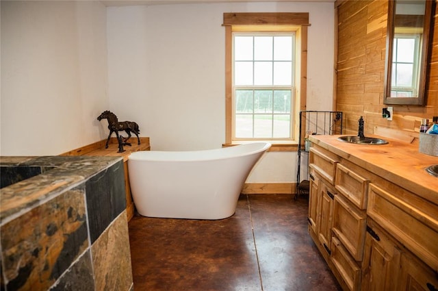 16301 Lewis Rd, Lexington, OK 73051 - bathroom featuring a freestanding bath, concrete flooring, and double vanity