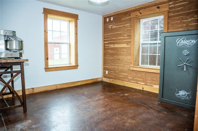 16301 Lewis Rd, Lexington, OK 73051 - unfurnished dining area featuring concrete floors, wooden walls, healthy amount of natural light, and baseboards
