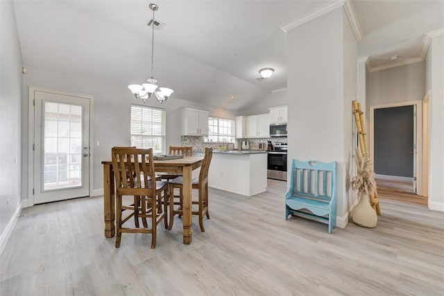 2333 Berry Ln, Midwest City, OK 73130 - dining room featuring light wood-type flooring, lofted ceiling, a chandelier, ornamental molding, and baseboards